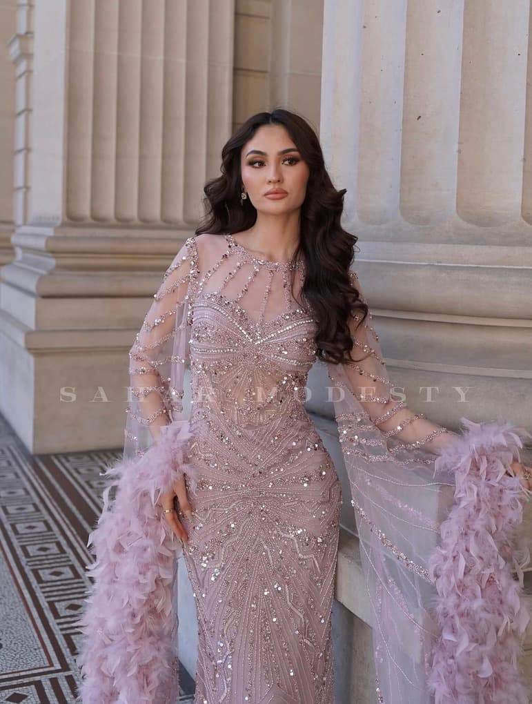 Close view of blush crystal beadwork and feather-trim modest sleeves.
